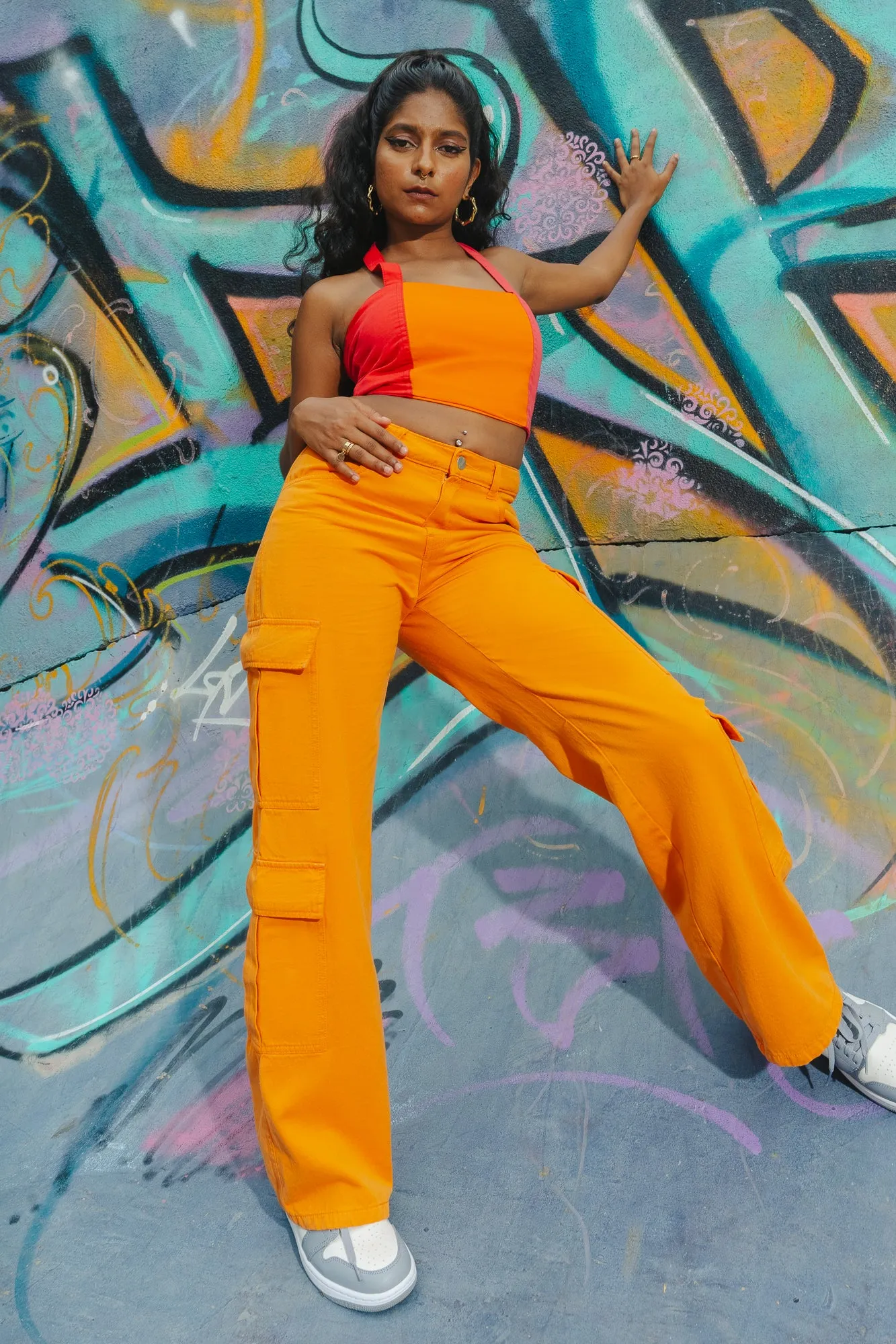 Sure! To optimize the title for better searchability and appeal, we can include descriptors that highlight the products features, style, and potential use cases. Heres an optimized title:

Trendy Candy Orange High-Waisted Cargo Pants for Women - Stylish and Functional Streetwear